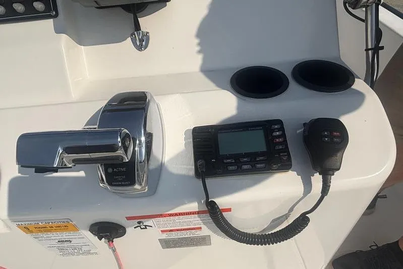 Slide: The Image of Control panel of a 2012 Boston Whaler 210 Montauk boat with radio and throttle. - 17