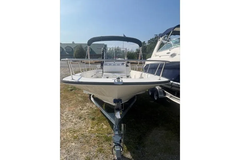 Slide: The Image of 2012 Boston Whaler 210 Montauk boat on trailer, parked outdoors. - 4