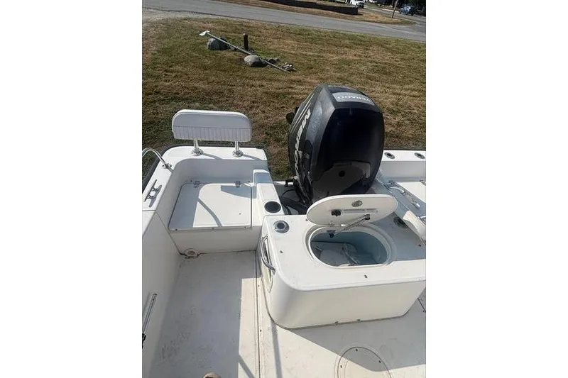 Slide: The Image of 2012 Boston Whaler 210 Montauk boat interior with engine and seating. - 7