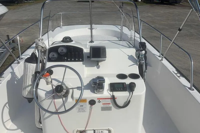 Slide: The Image of 2012 Boston Whaler 210 Montauk boat dashboard with steering wheel and navigation equipment. - 8