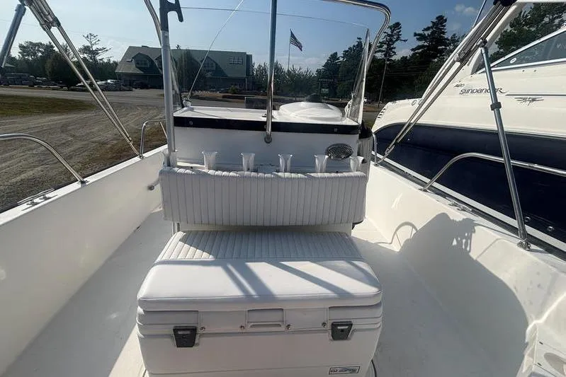 Slide: The Image of 2012 Boston Whaler 210 Montauk boat interior with seating and rod holders. - 9