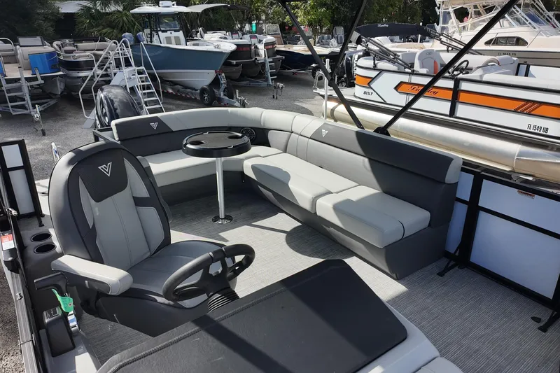 Slide: The Image of 2026 Viaggio Lago V 20 C pontoon boat interior with gray seating and steering console. - 11