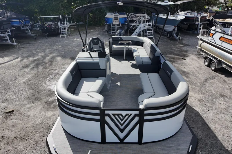 Slide: The Image of 2026 Viaggio Lago V 20 C pontoon boat with spacious seating, parked in a marina. - 4