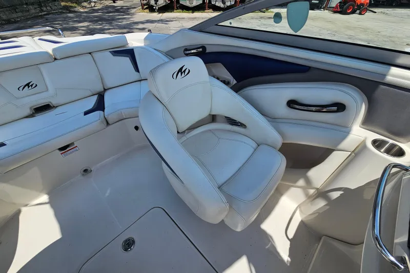 Slide: The Image of 2011 Monterey 244FS boat interior with white seating and cup holders. - 12