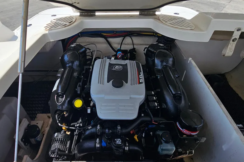 Slide: The Image of Engine compartment of a 2011 Monterey 244FS boat, showcasing a powerful motor. - 14