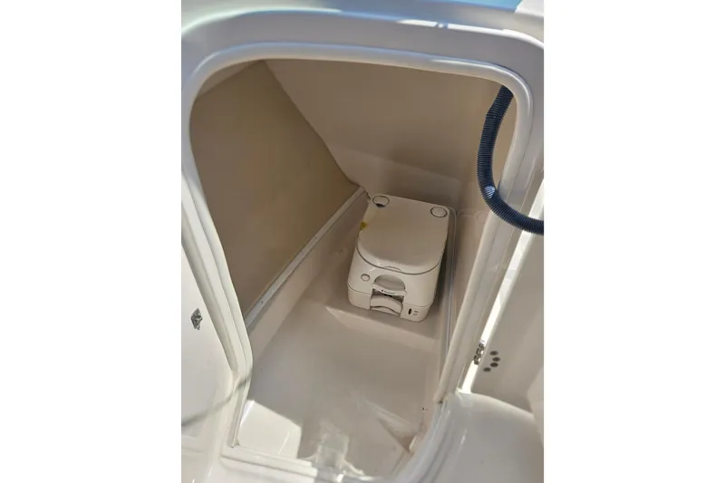 Slide: The Image of 2011 Monterey 244FS boat interior with compact portable toilet. - 15