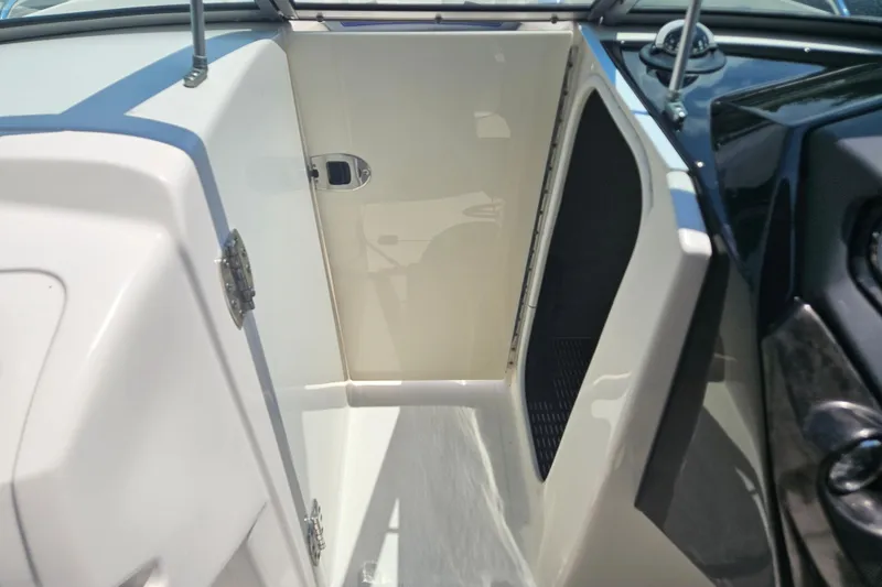 Slide: The Image of 2011 Monterey 244FS boat interior showing storage compartment and sleek design. - 16