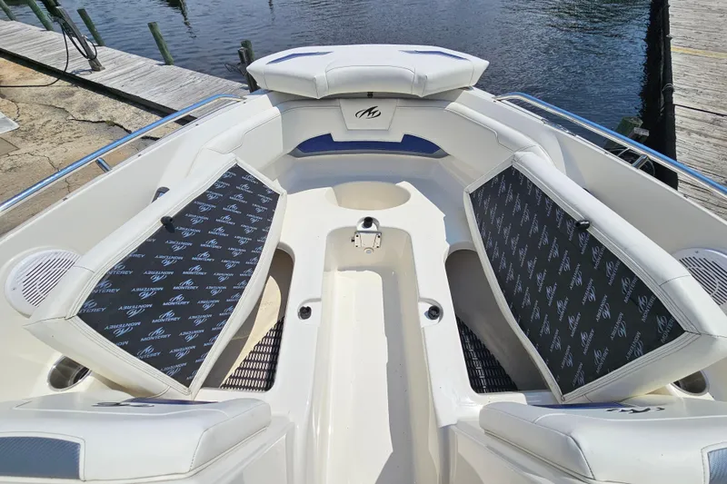 Slide: The Image of 2011 Monterey 244FS boat interior with cushioned seating and water view. - 20