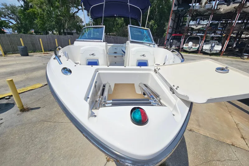 Slide: The Image of 2011 Monterey 244FS boat with open storage compartment, docked outdoors. - 7