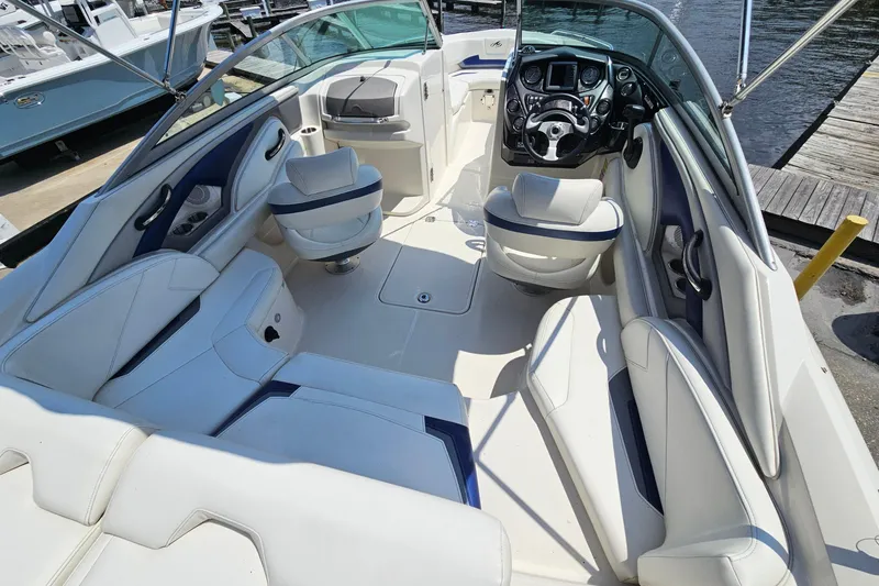 Slide: The Image of 2011 Monterey 244FS boat interior with white seating and modern dashboard. - 9