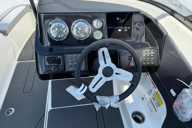 Slide: The Image of 2025 Bayliner V20i boat dashboard with steering wheel and instrument panel. - 11