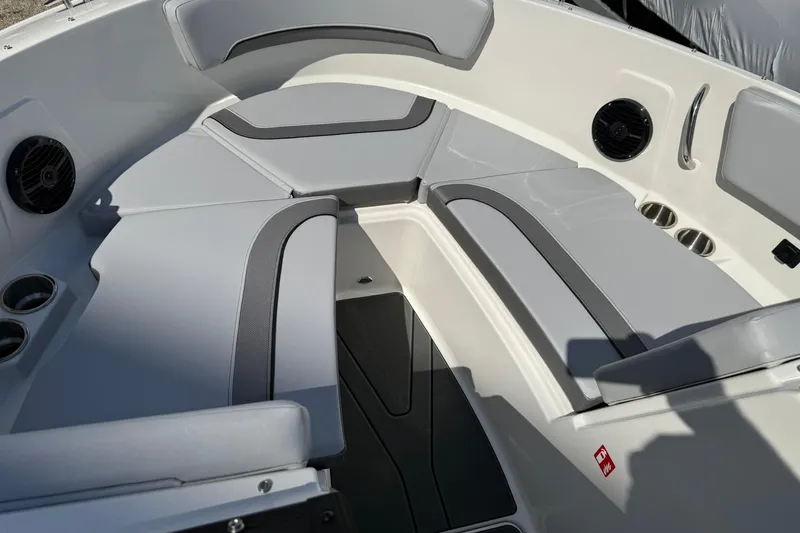 Slide: The Image of 2025 Bayliner V20i boat interior with gray seating and cup holders. - 12