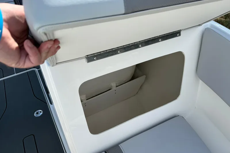 Slide: The Image of 2025 Bayliner V20i boat storage compartment with open seat lid. - 14