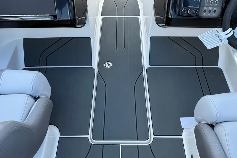 Slide: The Image of 2025 Bayliner V20i boat interior with sleek seating and modern dashboard design. - 15