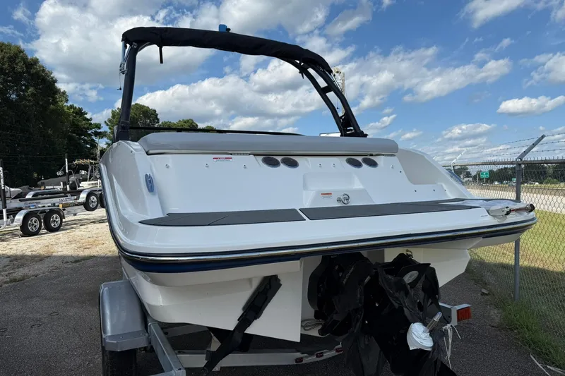 Slide: The Image of 2025 Bayliner V20i boat on trailer, rear view, under a partly cloudy sky. - 5