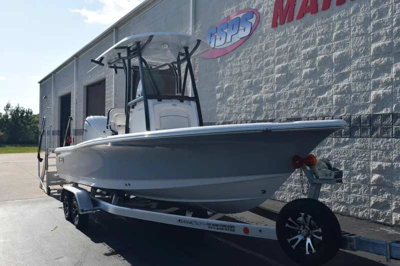 Slide: The Image of 2026 Sea Hunt BX 22 BR boat on trailer outside dealership building. - 2