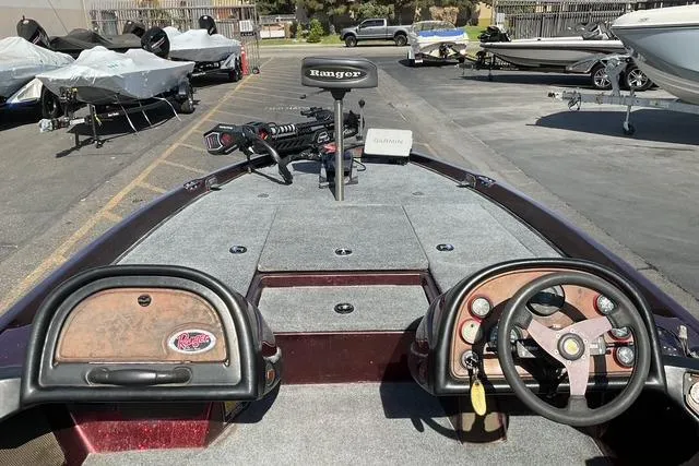 Slide: The Image of 2000 Ranger 518SVX Comanche boat interior with steering wheel and control panel. - 14