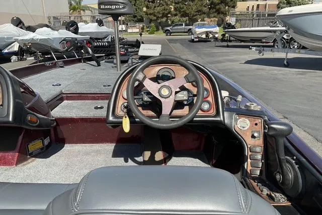 Slide: The Image of 2000 Ranger 518SVX Comanche boat interior with steering wheel and control panel. - 16