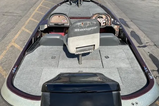 Slide: The Image of 2000 Ranger 518SVX Comanche boat interior with gray carpet and steering console. - 18