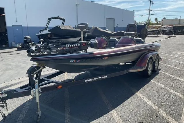 Slide: The Image of 2000 Ranger 518SVX Comanche boat on trailer in parking lot. - 2