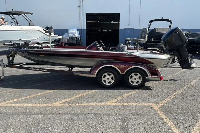 Slide: The Image of 2000 Ranger 518SVX Comanche boat on trailer in parking lot. - 4