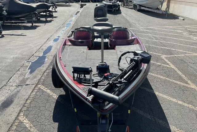 Slide: The Image of 2000 Ranger 518SVX Comanche boat parked on asphalt, featuring fishing equipment. - 5