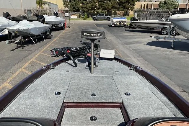 Slide: The Image of 2000 Ranger 518SVX Comanche boat with Garmin equipment, parked outdoors. - 6