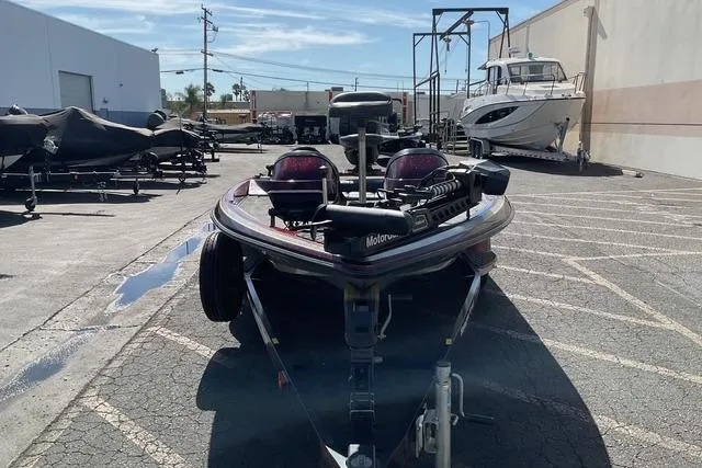 Slide: The Image of 2000 Ranger 518SVX Comanche boat on trailer in a marina parking lot. - 7