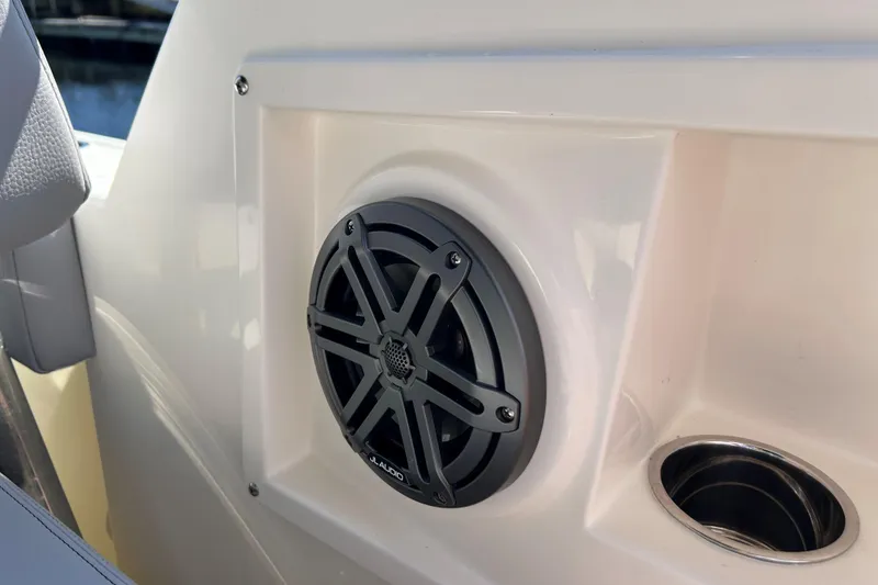Slide: The Image of 2026 Cobia 220 Dual Console boat speaker and cup holder detail. - 15