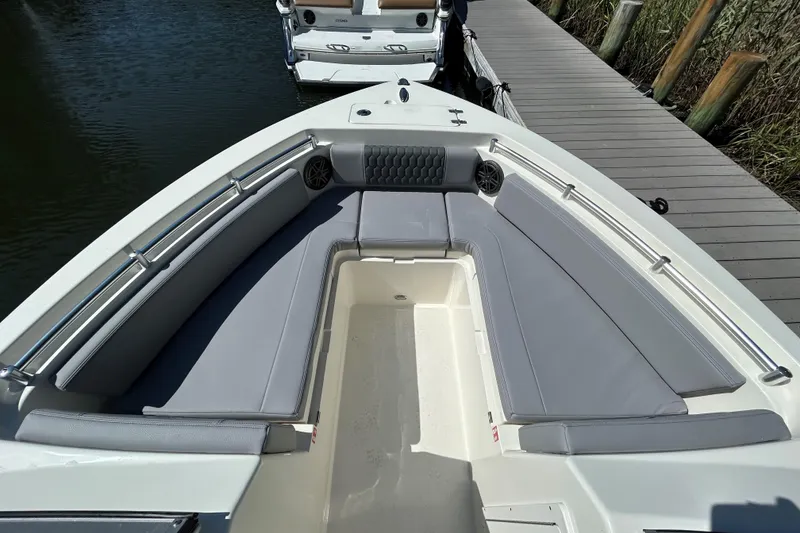 Slide: The Image of 2026 Cobia 220 Dual Console boat with spacious seating at the dock. - 16