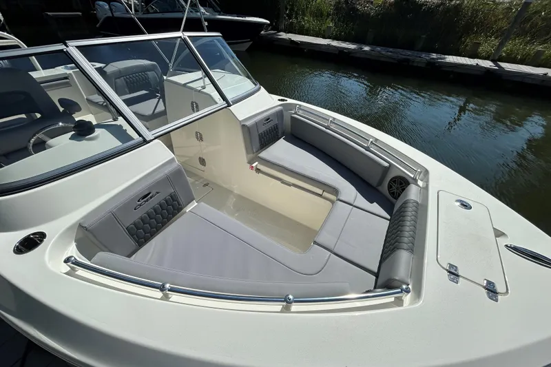Slide: The Image of 2026 Cobia 220 Dual Console boat with spacious seating and sleek design. - 19