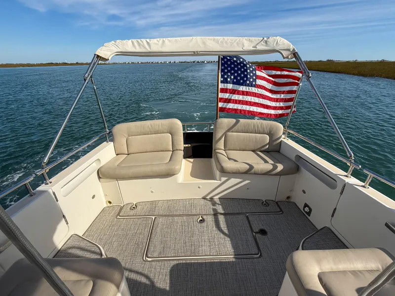 Slide: The Image of 2015 MJM 36z Downeast boat interior with American flag, cruising on calm waters. - 10