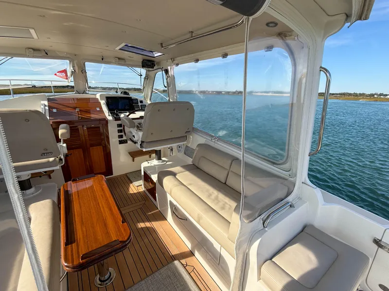 Slide: The Image of Interior of 2015 MJM 36z Downeast boat with seating and helm, overlooking water. - 15