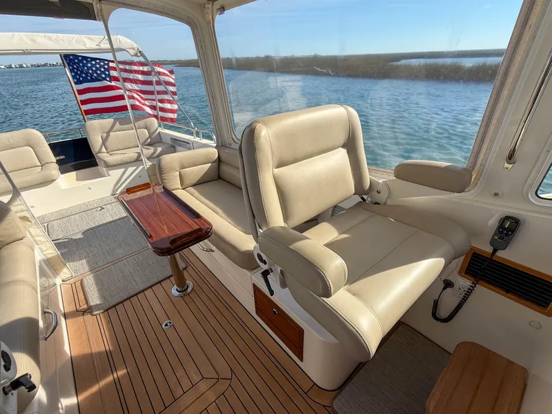 Slide: The Image of Luxurious 2015 MJM 36z Downeast boat interior with leather seating and wooden flooring. - 18