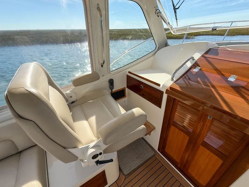 Slide: The Image of Interior of 2015 MJM 36z Downeast boat with leather seating and wooden cabinetry. - 19