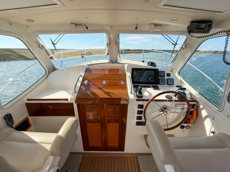 Slide: The Image of 2015 MJM 36z Downeast boat interior with steering wheel and navigation equipment. - 20