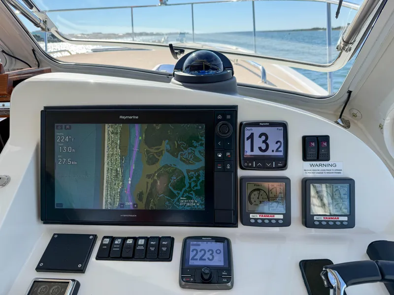 Slide: The Image of MJM 36z Downeast 2015 boat dashboard with navigation and control displays. - 25