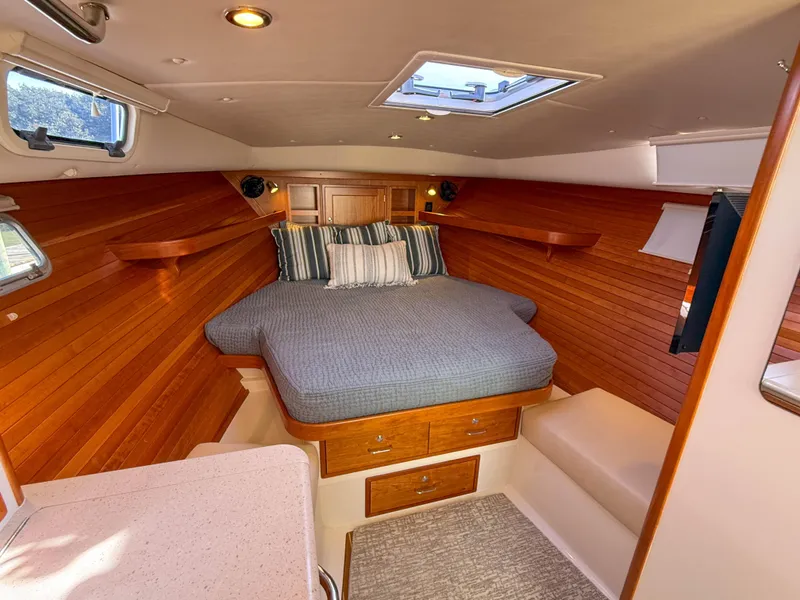 Slide: The Image of Luxurious cabin interior of 2015 MJM 36z Downeast yacht with cozy bed and wood paneling. - 27