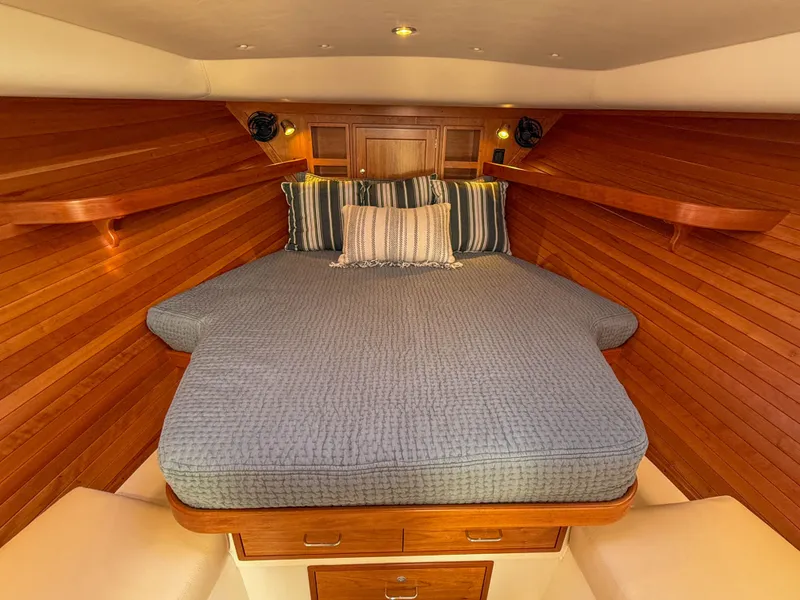Slide: The Image of Luxurious cabin interior of 2015 MJM 36z Downeast with cozy bedding and wooden finish. - 28