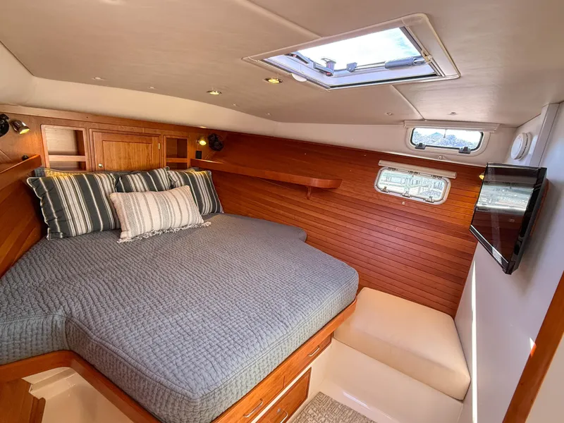Slide: The Image of Luxurious cabin interior of 2015 MJM 36z Downeast yacht with cozy bedding and wood paneling. - 29