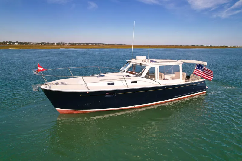 Slide: The Image of 2015 MJM 36z Downeast boat cruising on calm waters under clear skies. - 3