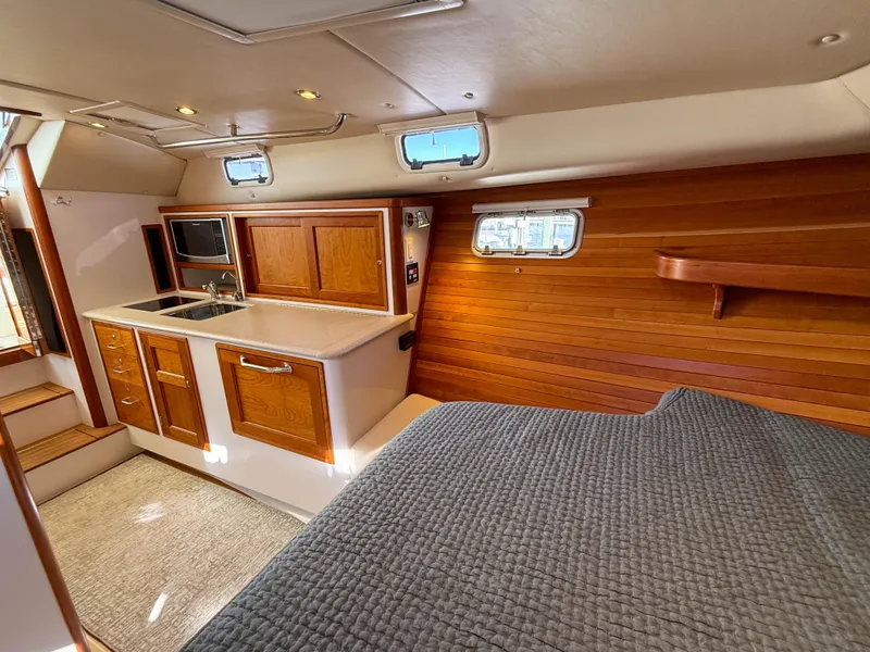 Slide: The Image of Interior of 2015 MJM 36z Downeast yacht with wood paneling and kitchenette. - 31