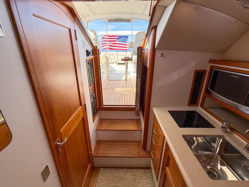 Slide: The Image of Interior of 2015 MJM 36z Downeast yacht with kitchenette and American flag view. - 34