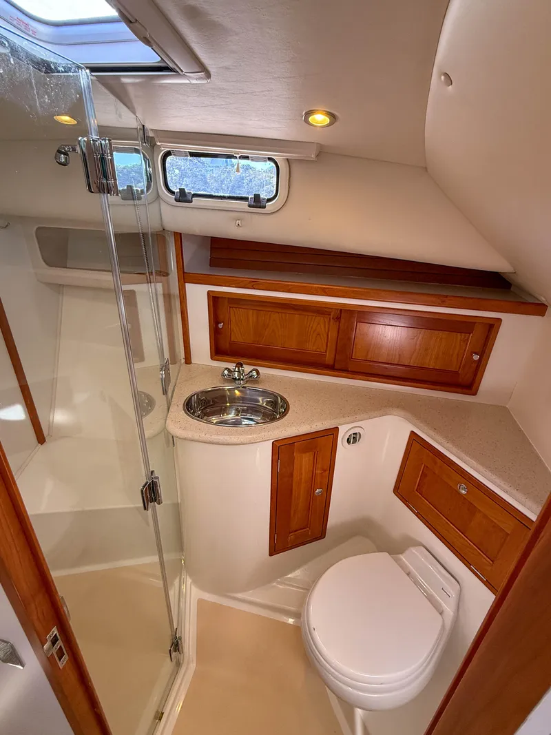 Slide: The Image of 2015 MJM 36z Downeast yacht bathroom with wood cabinetry and modern fixtures. - 36