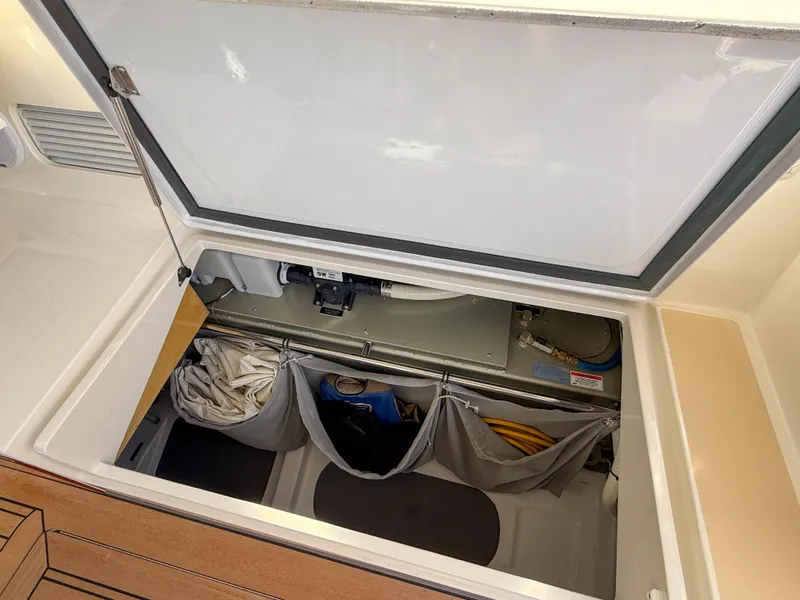 Slide: The Image of Storage compartment of 2015 MJM 36z Downeast boat, featuring organized gear and equipment. - 48