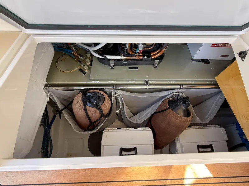 Slide: The Image of Engine compartment of 2015 MJM 36z Downeast boat with storage and equipment. - 49