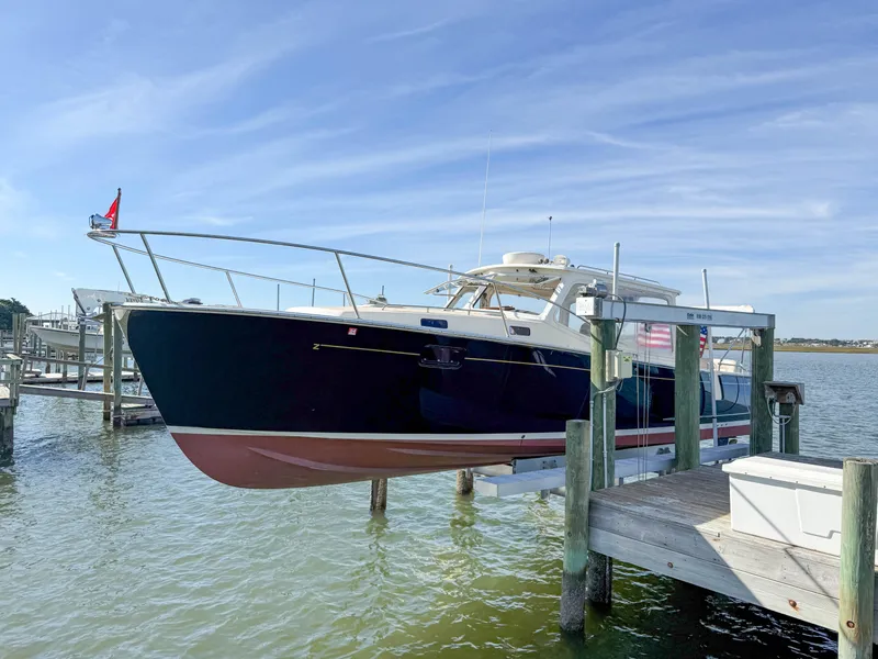 Slide: The Image of 2015 MJM 36z Downeast boat docked on a lift by the water. - 7