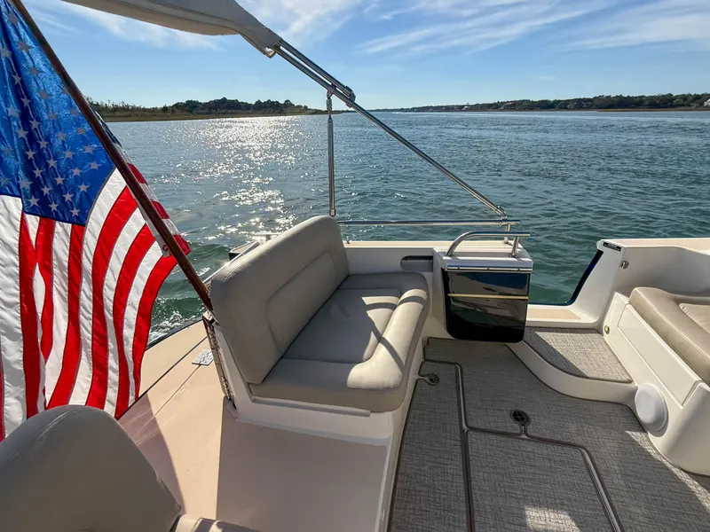 Slide: The Image of 2015 MJM 36z Downeast boat with American flag on calm water. - 9