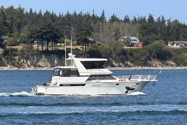The Image of 1991 Californian 52 Cockpit Motor Yacht cruising on a scenic waterway. - 0