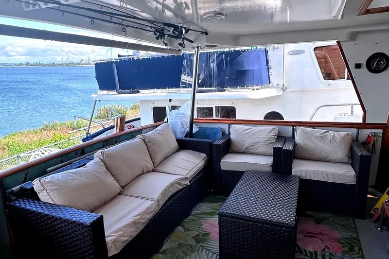 Slide: The Image of 1991 Californian 52 Cockpit Motor Yacht with outdoor seating, overlooking serene waterfront. - 10